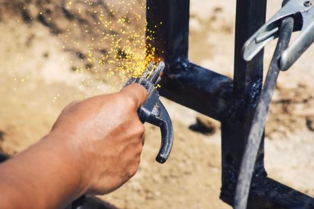 a-worker-is-welding-iron-without-wearing-gloves-light-welding-work-free-photo