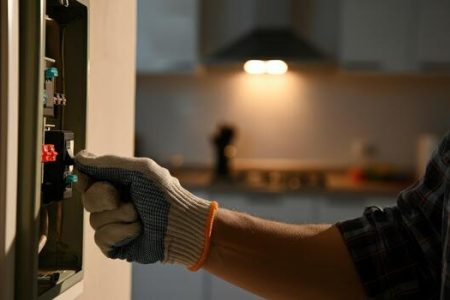 person-wearing-gloves-working-on-electrical-circuit-breaker-in-home-free-photo