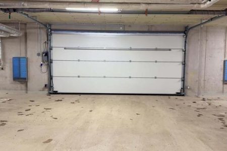 this-is-a-spacious-garage-interior-showcasing-a-modern-white-door-that-enhances-its-appeal-free-photo