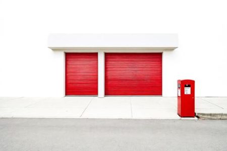 two-red-garage-doors-and-a-red-mailbox-free-photo